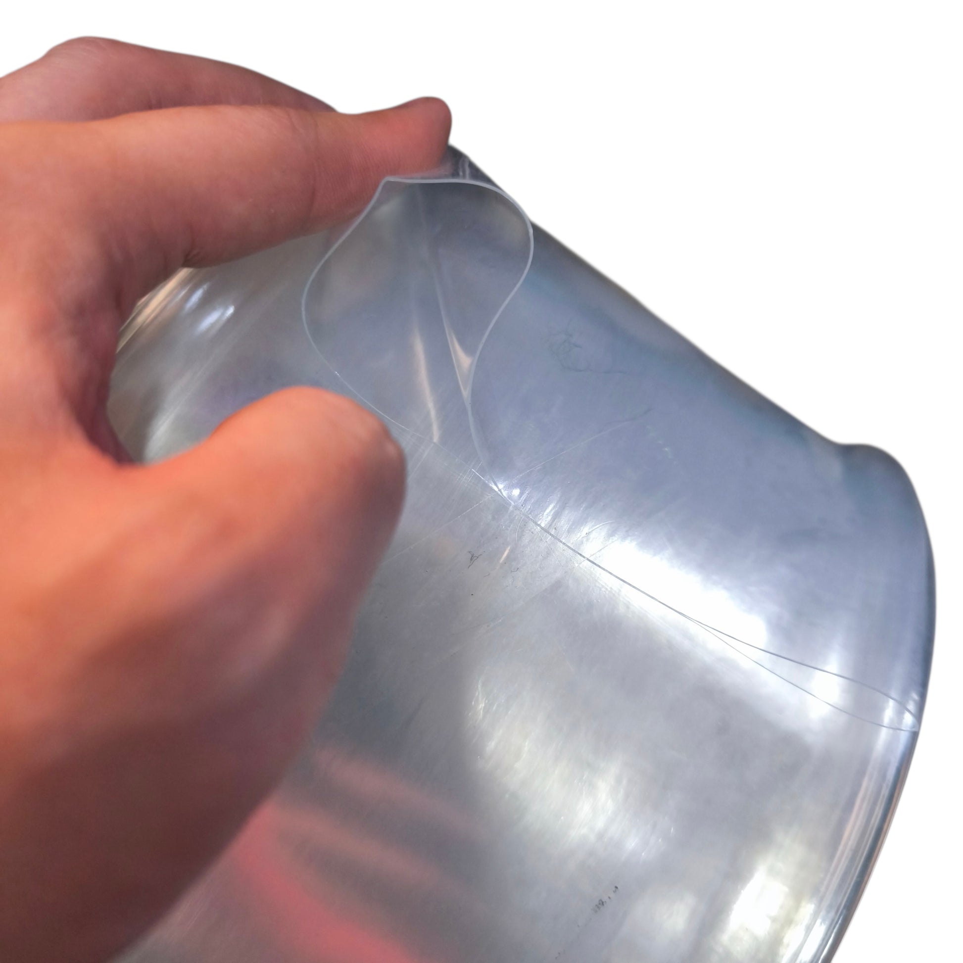 Clear plastic sheet held by a hand on a white background