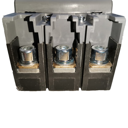 A close-up of a three-terminal electrical terminal block connector with gray plastic housing and three exposed metal screw terminals on a white background.