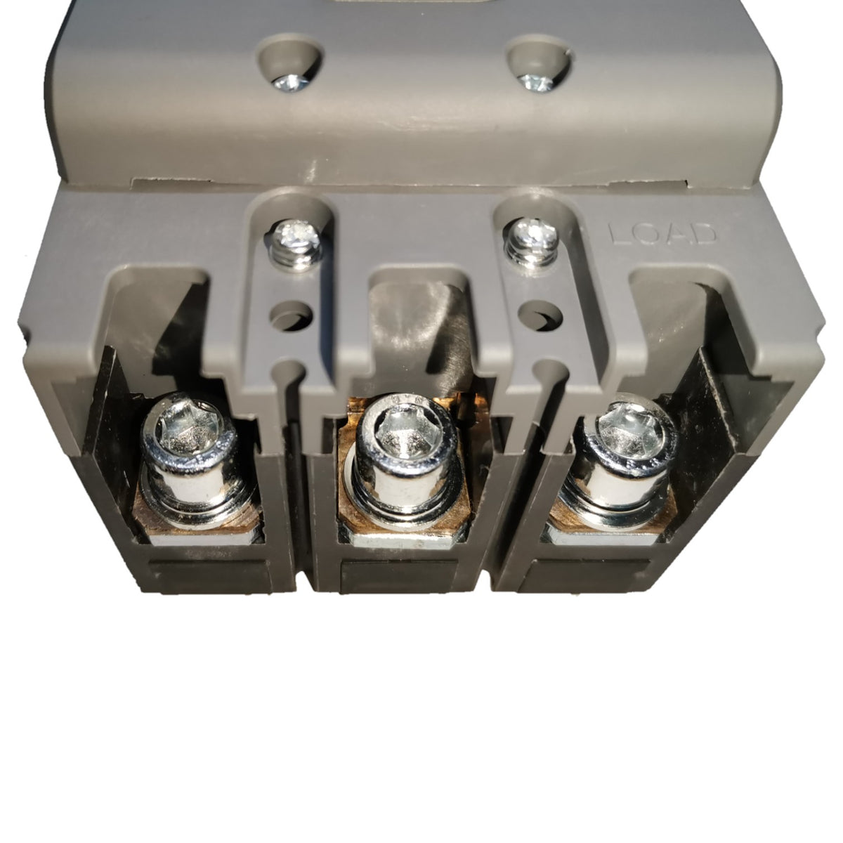 A close-up of a gray electrical terminal block connector with three metal screw terminals visible on a white background.