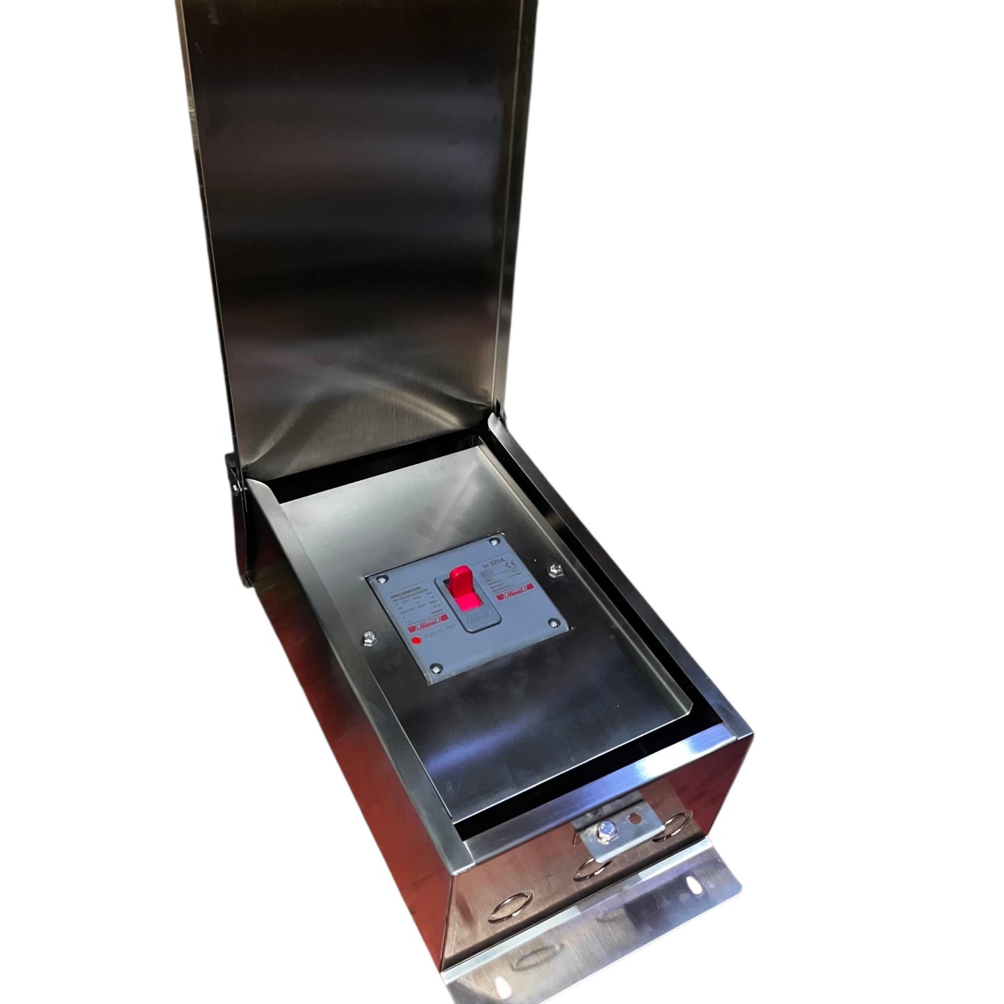 A stainless steel electrical compartment or control box with its lid open, showing a metal panel with a red switch and small labels, photographed on a plain white background.