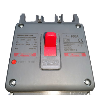 A gray electrical circuit breaker with a prominent red central trip switch and red printed text, photographed on a plain white background.