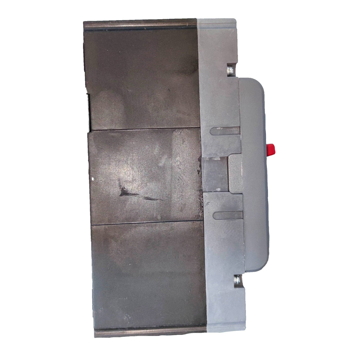 A heavy-duty industrial metal component, likely a valve body or filter housing, featuring a dark gray cast metal face, a silver-gray side casing, and a small red release button.
