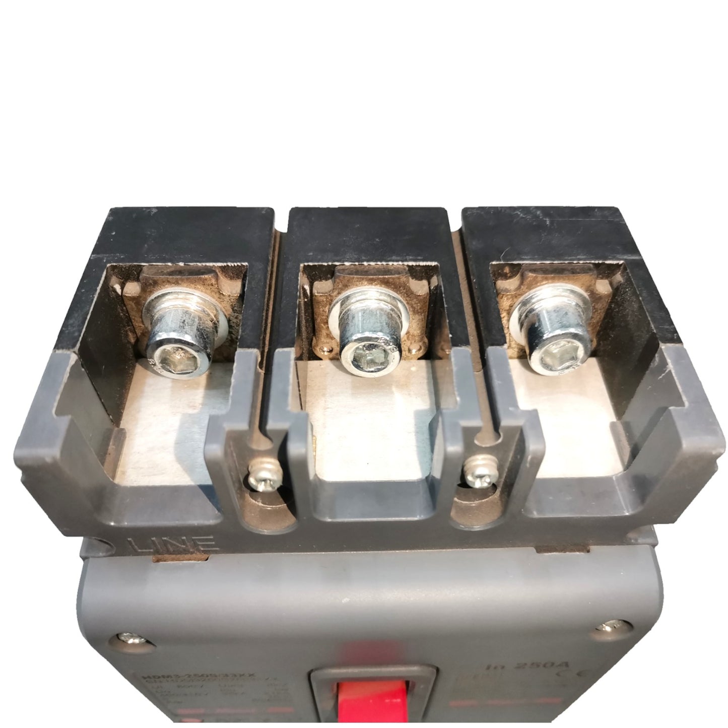 A close-up of a three-terminal electrical contactor or switch component with metal screw terminals and a red switch lever on a gray housing, isolated on a white background.