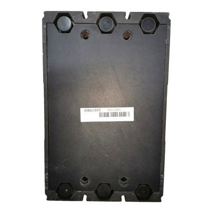 A black heavy-duty metal industrial component, likely a hydraulic or mechanical valve housing, featuring pre-drilled mounting holes and a white barcode label in the center.
