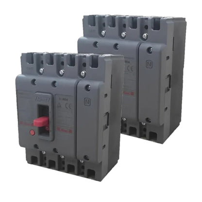Two gray electrical circuit breakers shown on a plain white background, with one in front and one behind. The front breaker has a red switch handle and printed specifications on the side.
