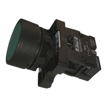 A black industrial push-button module with a green circular button face, photographed on a plain white background.