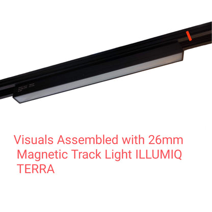 A close-up of a black magnetic track light fixture shown diagonally on a white background, with red text below reading 'Visuals Assembled with 26mm Magnetic Track Light ILLUMIQ TERRA'.
