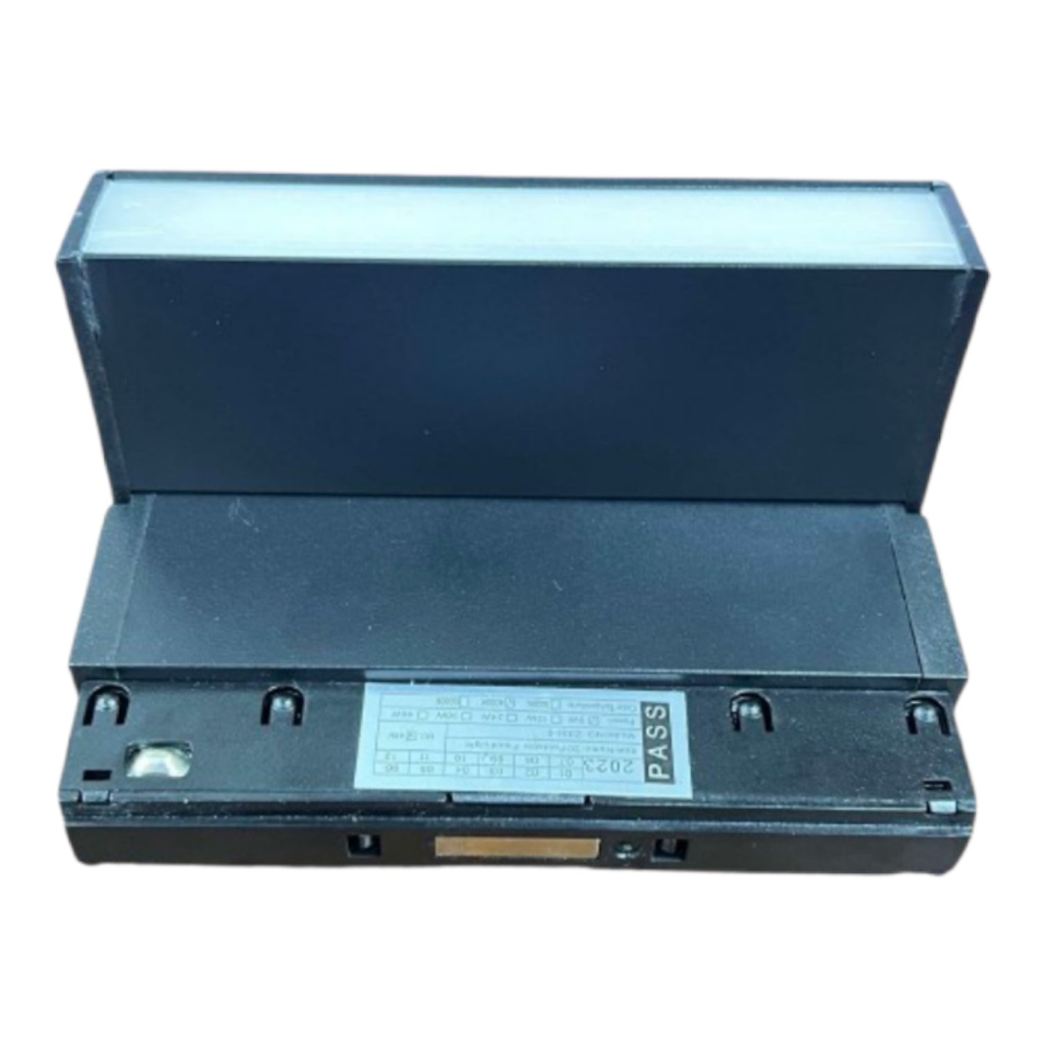 A black plastic electronic component or enclosure with a hinged lid, shown open against a plain white background. A white label with text is visible on the front.
