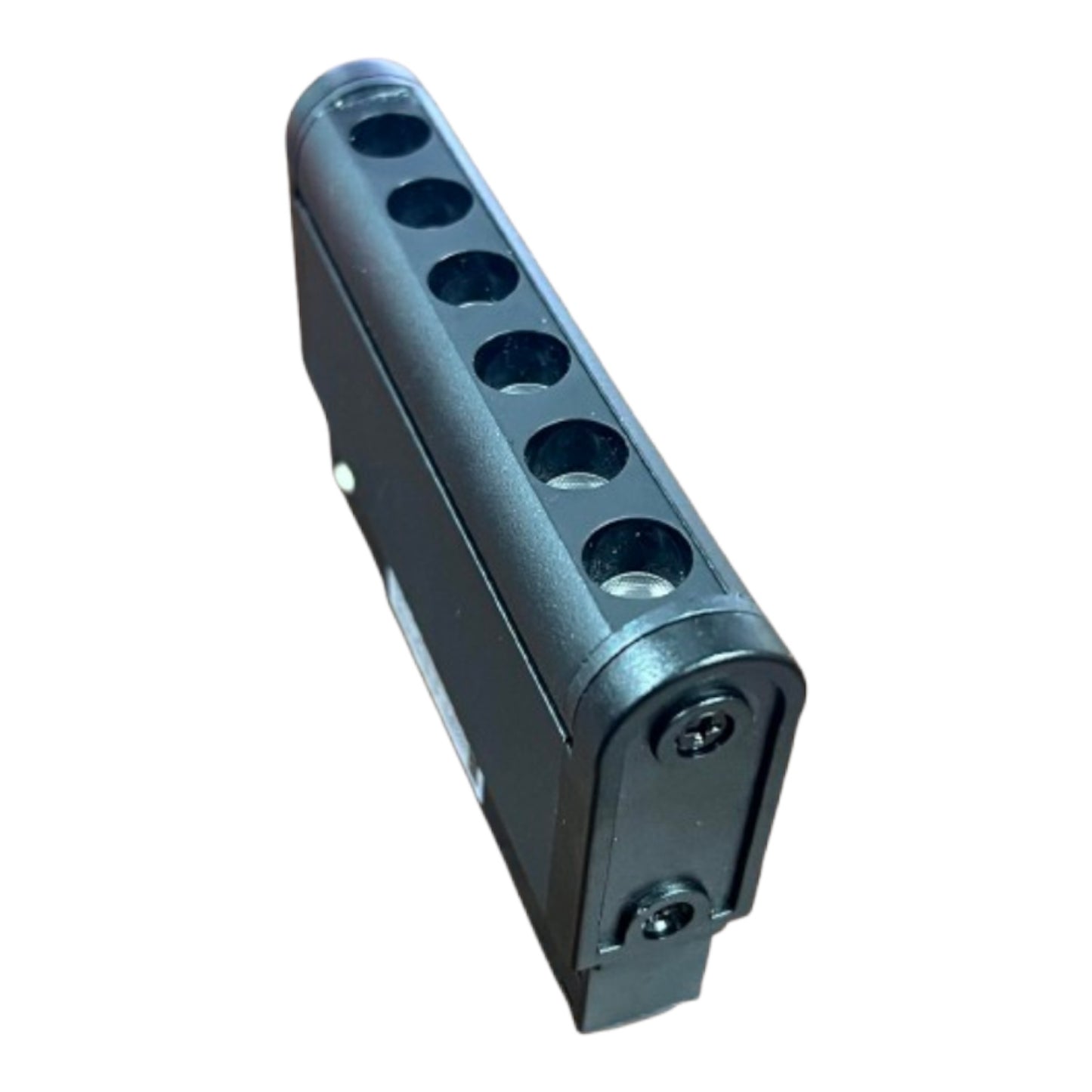 A black plastic multi-port connector block with six circular ports, shown at an angle on a plain white background.