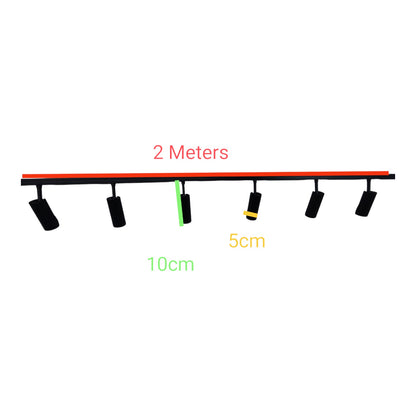 A black multi-light track fixture shown on a white background with overlaid dimension labels: '2 Meters' in red above the track, '10cm' in green below, and '5cm' in yellow near one spotlight.