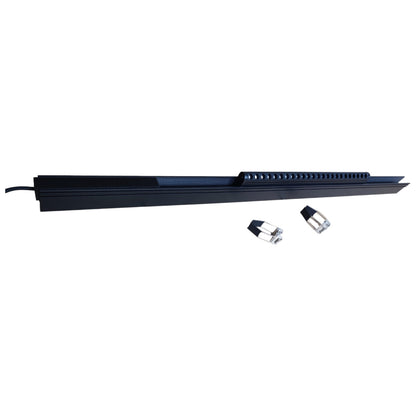Long black rectangular object with two small cylindrical items on a white background