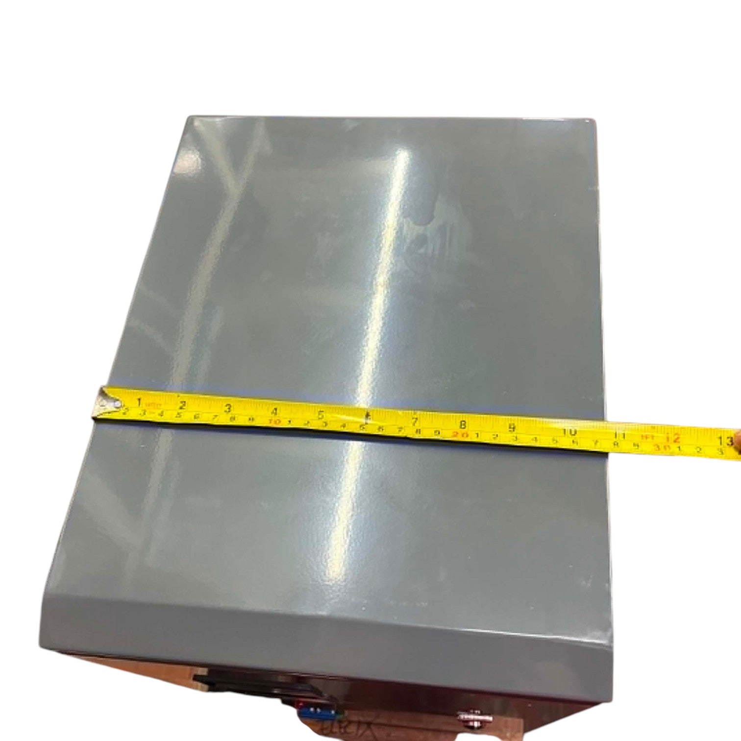 Metallic sheet with a measuring tape indicating its dimensions on a white background