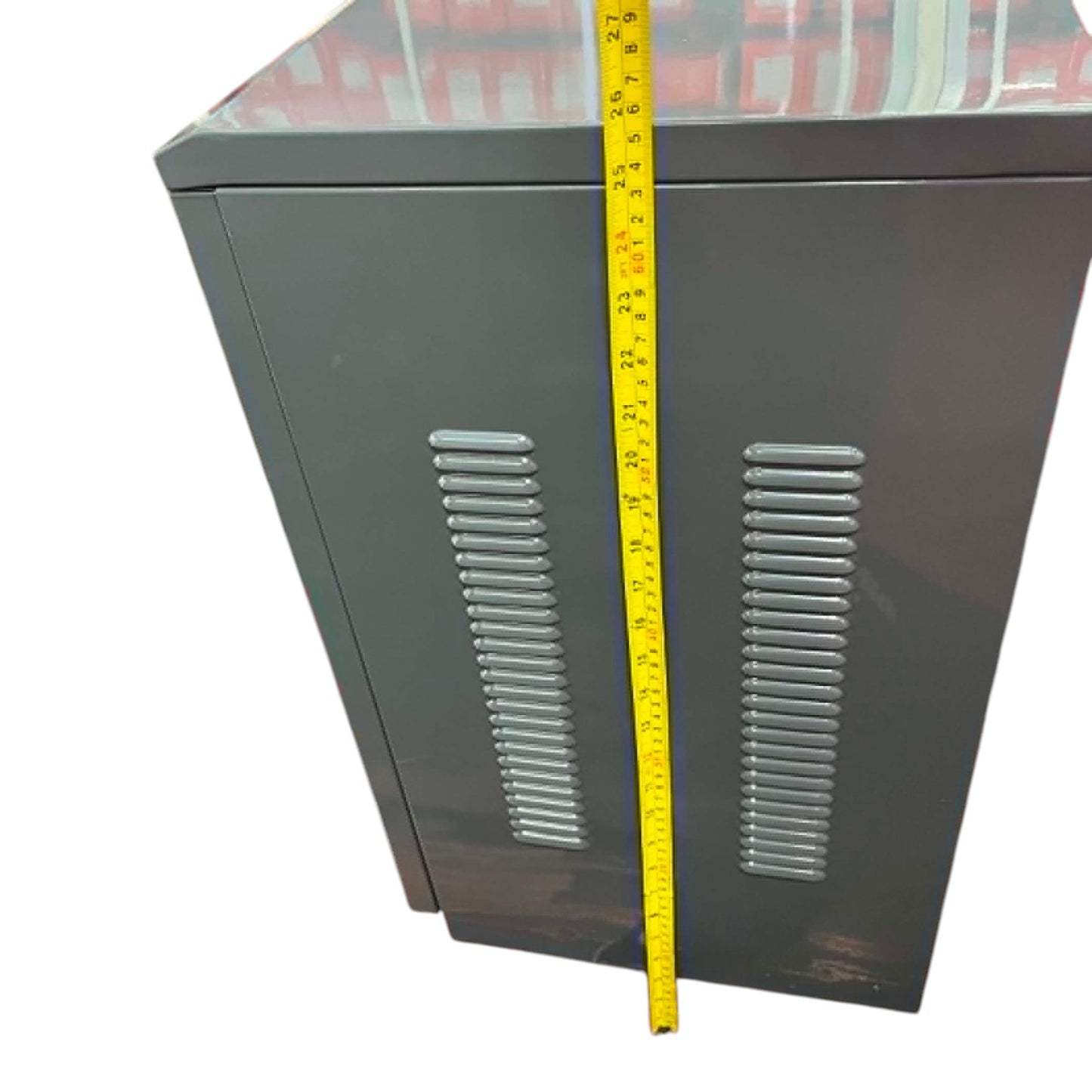 Metal cabinet with a measuring tape indicating dimensions on a white background