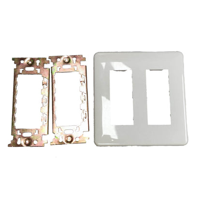 A pair of gold-toned metal electrical switch blade inserts next to a glossy white double-gang faceplate on a plain white background.