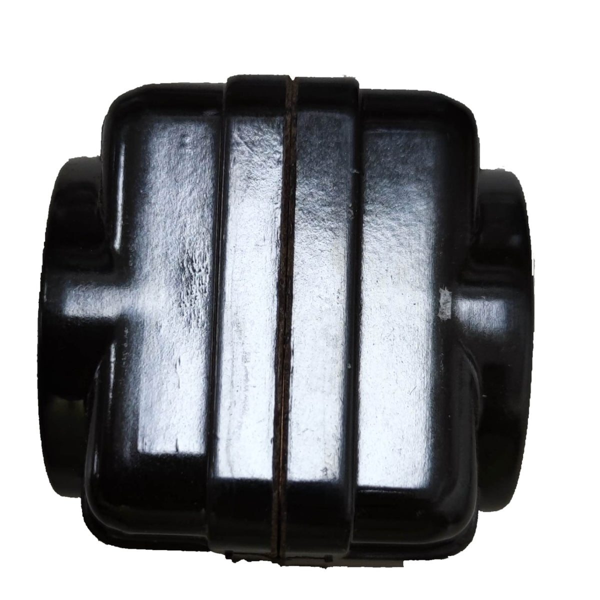 A black plastic automotive or machinery component with a ribbed, blocky design and circular side openings, shown against a plain white background.