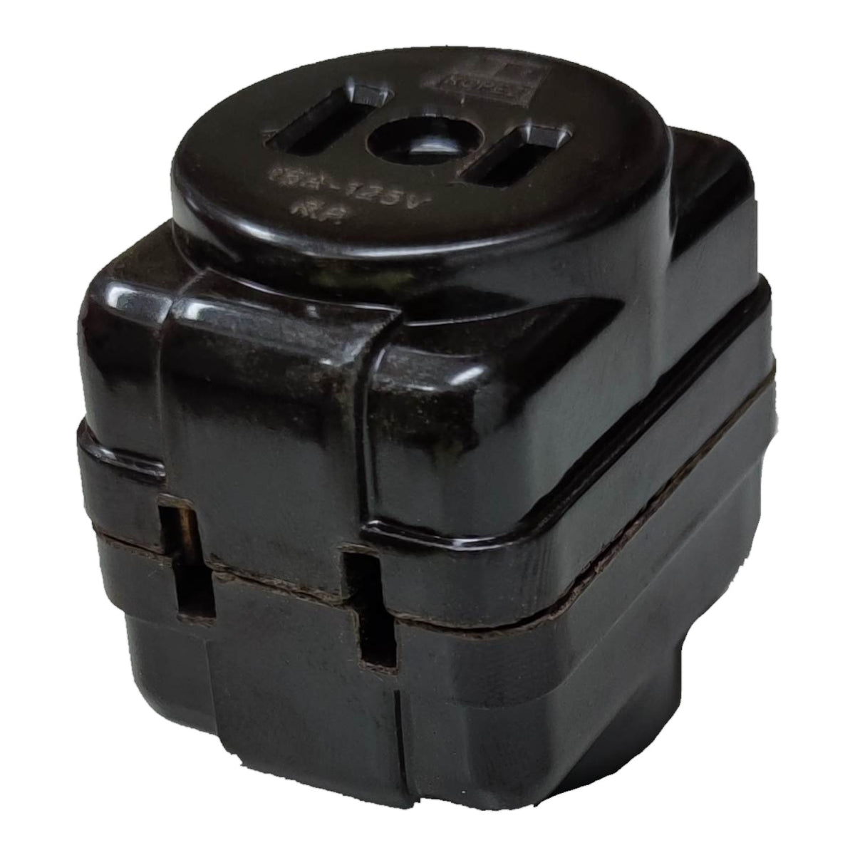 A black plastic electrical outlet adapter or junction block with a circular top featuring a two-prong outlet cutout, photographed on a plain white background.