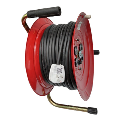 A red plastic extension reel spool wound with black cable, featuring a brass-colored handle, a black hand grip, and a small white plastic tag attached to the side, shown on a plain white background.