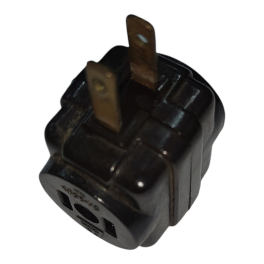 A black plastic electrical outlet adapter plug with two metal pins, isolated on a white background.