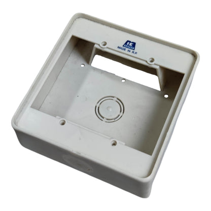 A white plastic electrical junction box cover with a handle cutout and mounting holes, featuring a blue 'MADE IN R.O.