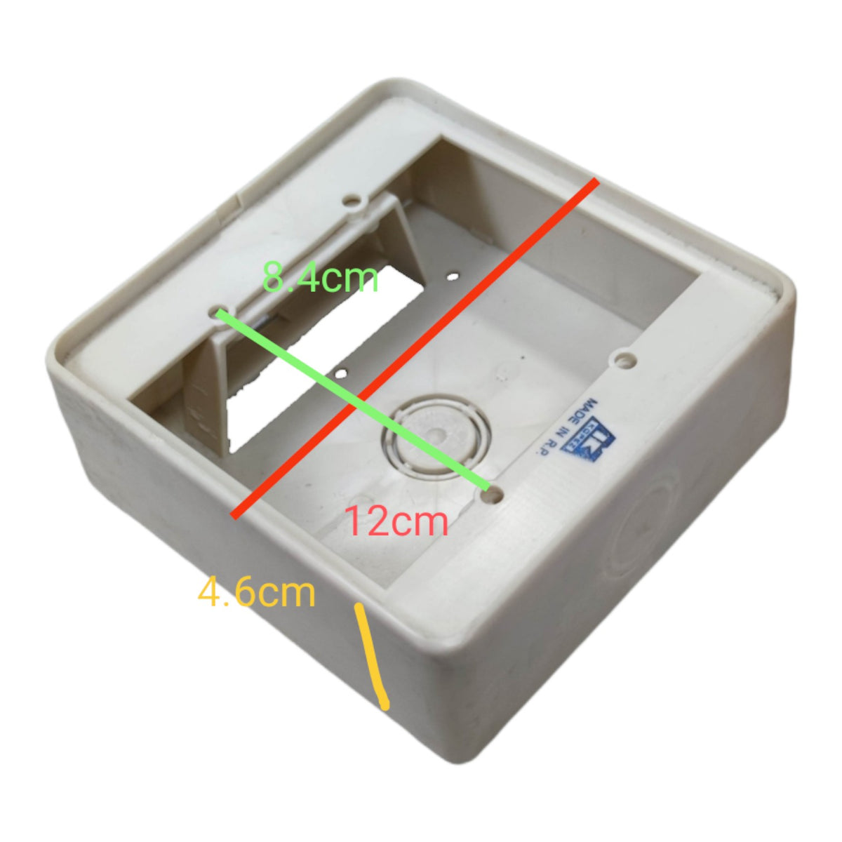 A white plastic electrical junction box shown from an overhead angle with overlaid dimension lines and measurements: 12 cm, 8.4 cm, and 4.