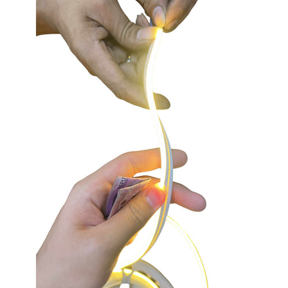 Hands holding a string of small lights against a white background
