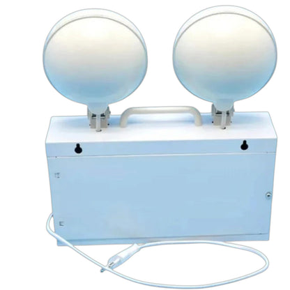 A dual-head emergency exit security light with a white metal box base, two large round dome-shaped reflectors, a top handle, and a power cord, shown on a plain white background.