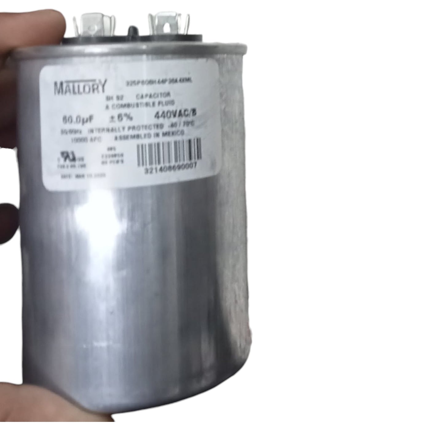 Capacitor with Mallory label held by a hand on a white background Mallory 60uF 440V Oiled Filled Capacitor with Aluminum Body Electx Electrical SUpply