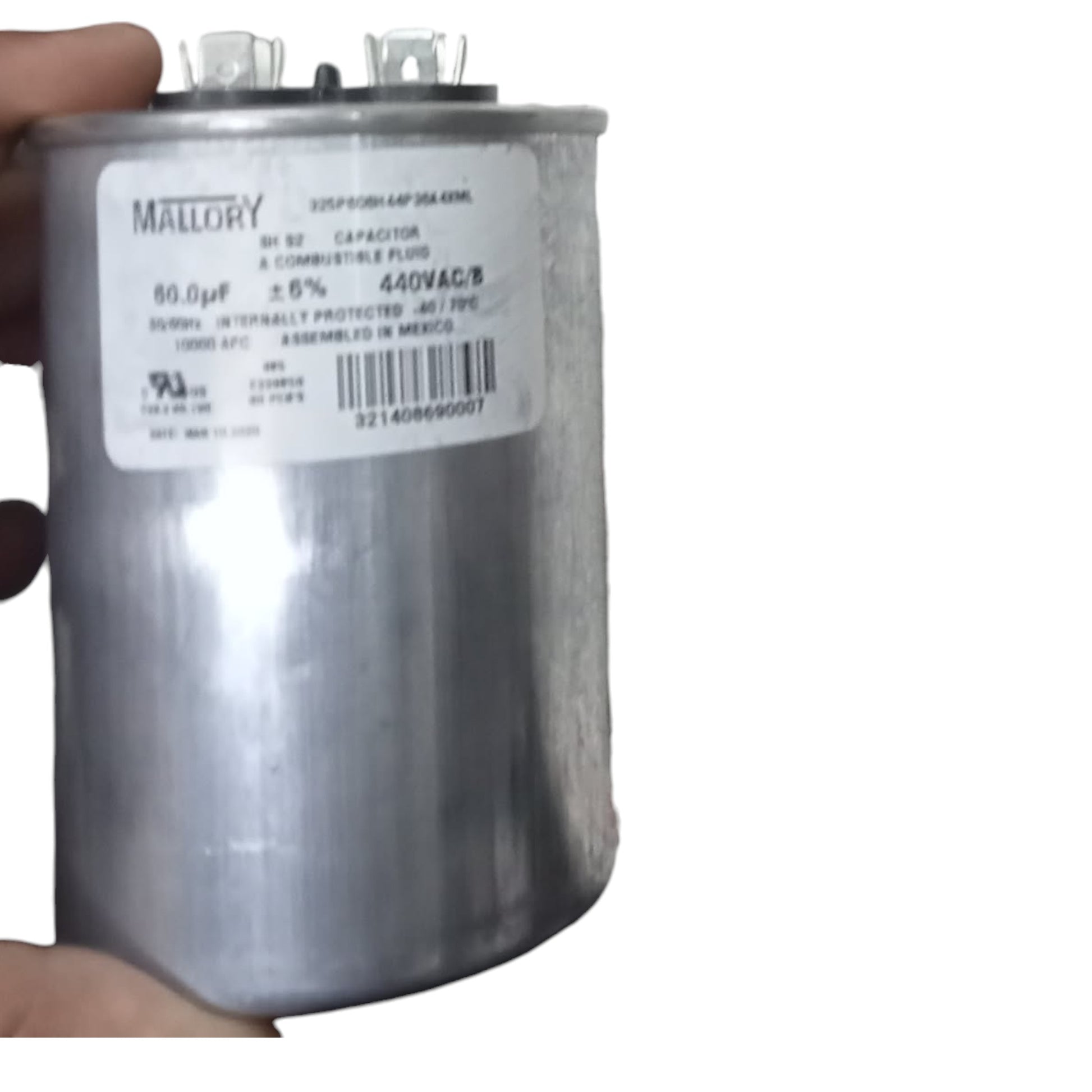 Capacitor with Mallory label held by a hand on a white background Mallory 60uF 440V Oiled Filled Capacitor with Aluminum Body Electx Electrical SUpply