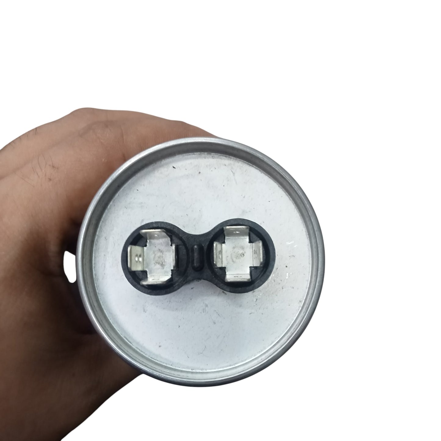 Hand holding a cylindrical metal component with two connectors on a white background Mallory 60uF 440V Oiled Filled Capacitor with Aluminum Body Electx Electrical SUpply