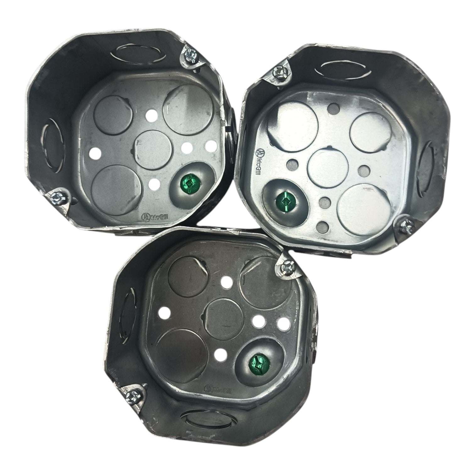 Three metallic octagonal mounting brackets or trays with circular cutouts and small green circular details, arranged on a plain white background.