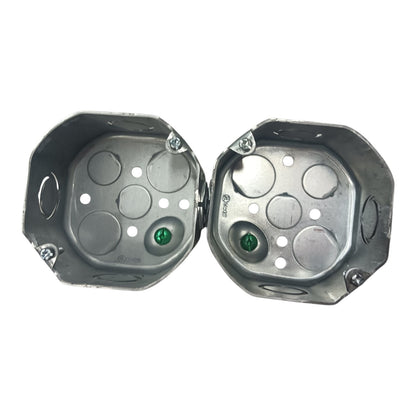 Two galvanized metal electrical junction boxes shown open against a plain white background.