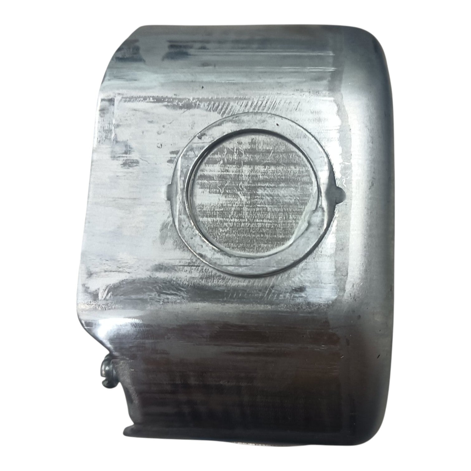 A used metallic silver rectangular component with a circular recessed detail, showing signs of wear, scratches, and heat discoloration, isolated on a white background.