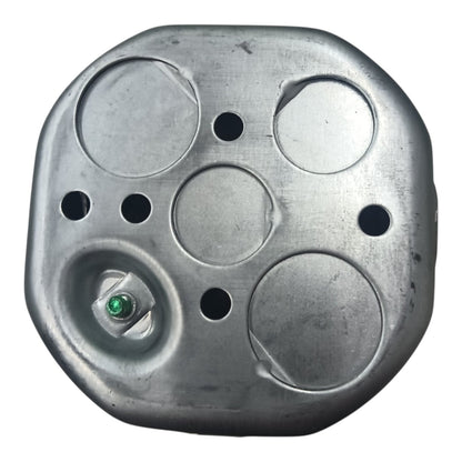 A metallic silver fuel tank lid with circular cutouts and a small green cap seal, shown against a plain white background.