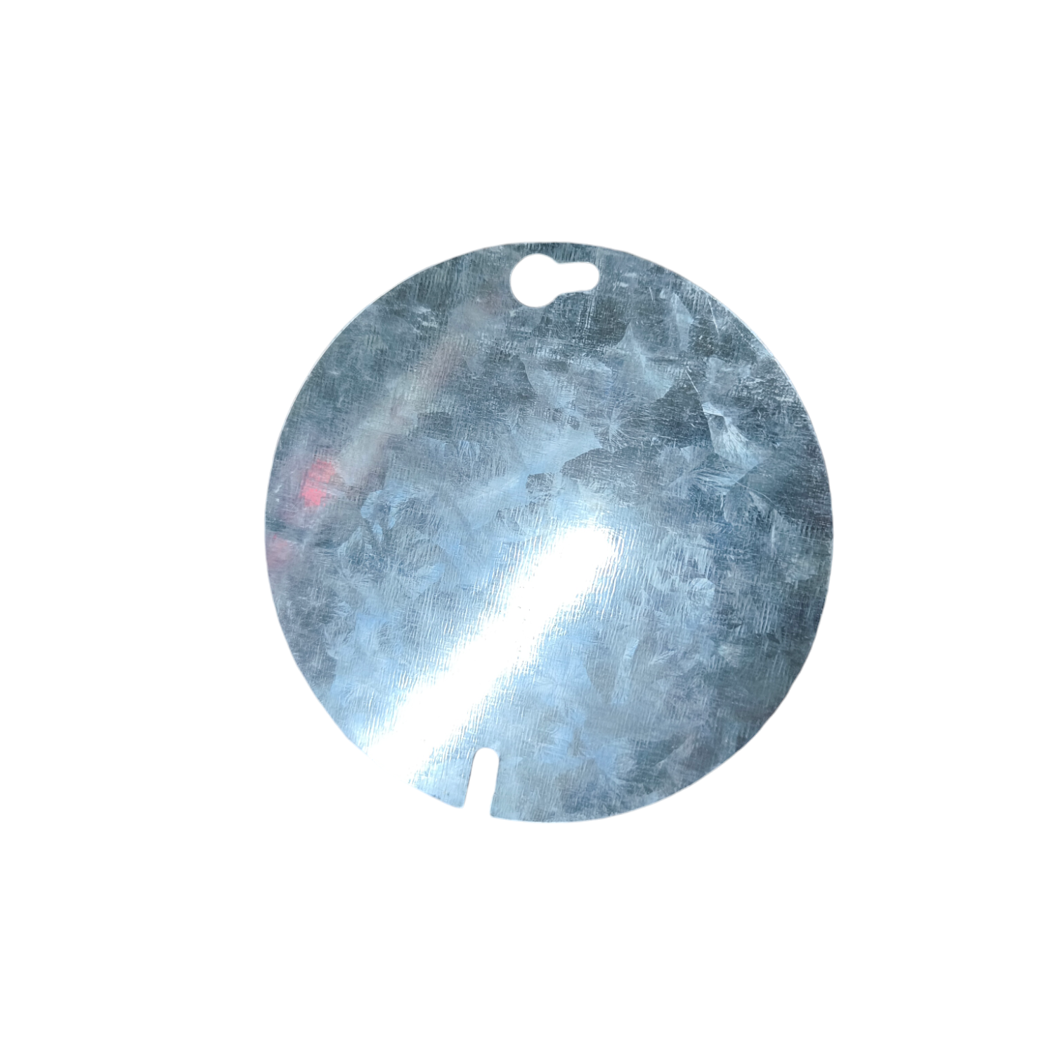Round metallic object with a reflective surface on a white background