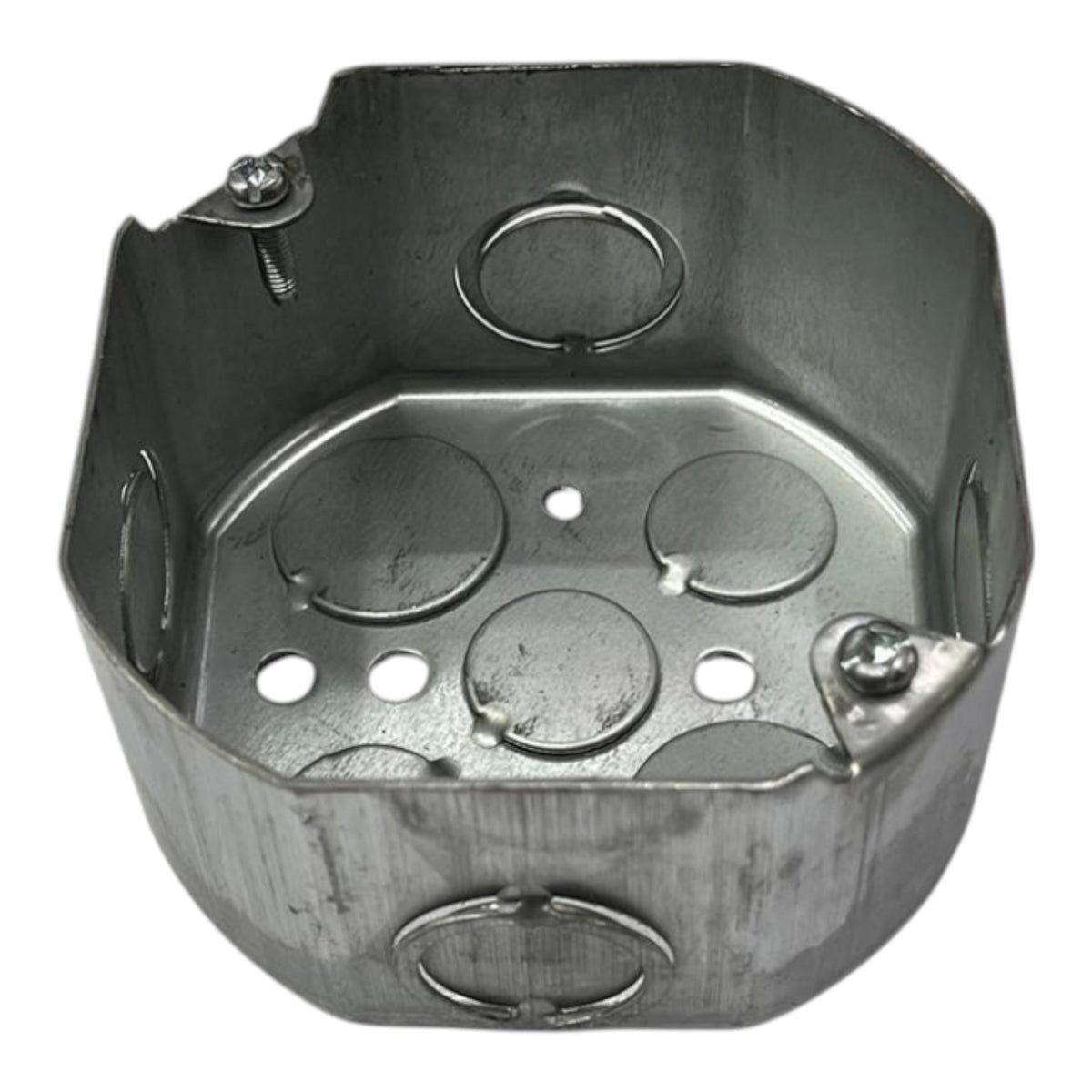 A metallic octagonal metal electrical junction box with pre-drilled screw holes and circular ring terminals on a plain white background.