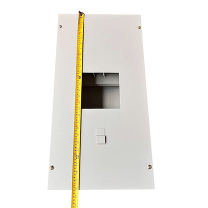 A white metal electrical junction box or panel with a rectangular cutout and a small tab, shown on a white background with a yellow tape measure running vertically along the left side for size reference.