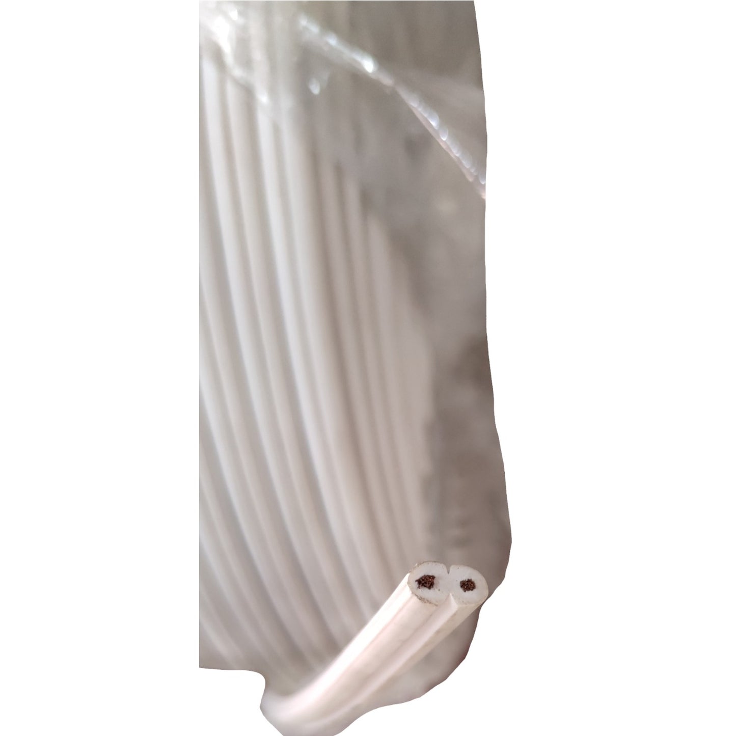 A close-up of a coiled white plastic tube or cable wrapped in clear plastic, with two ends visible at the bottom showing dark internal cores.