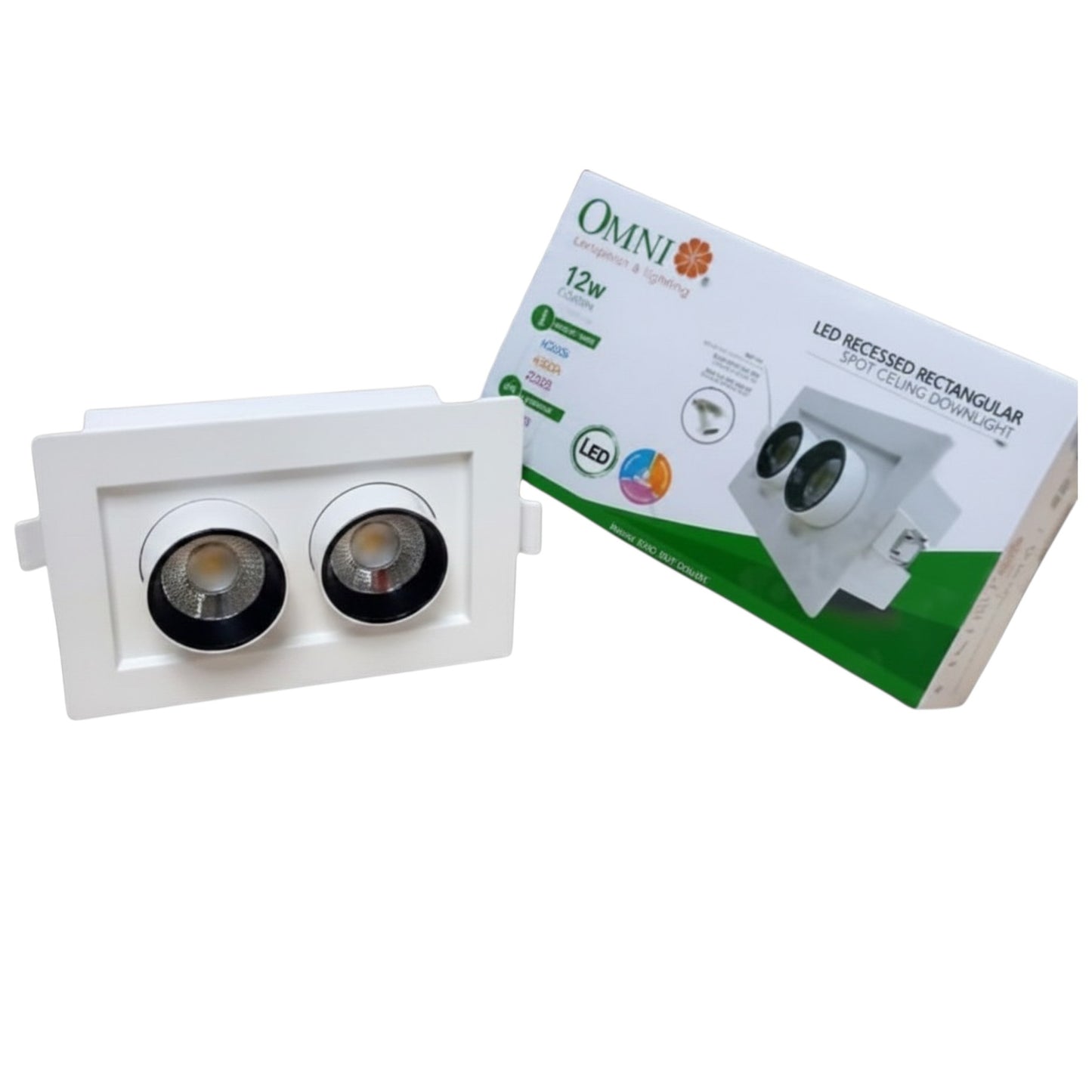 A white recessed dual-light LED downlight fixture shown in front of its white and green OMNI brand retail packaging box on a plain white background.