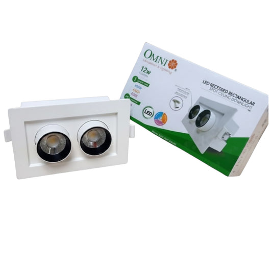 A white recessed dual-light LED downlight fixture shown in front of its white and green OMNI brand retail packaging box on a plain white background.