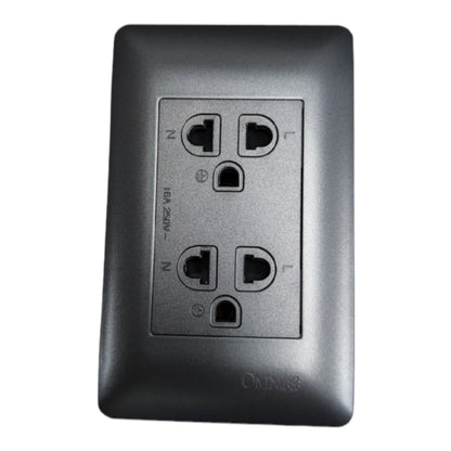 A black outdoor duplex outlet faceplate with a recessed center plate showing the outlet sockets and terminal labels, on a white background.