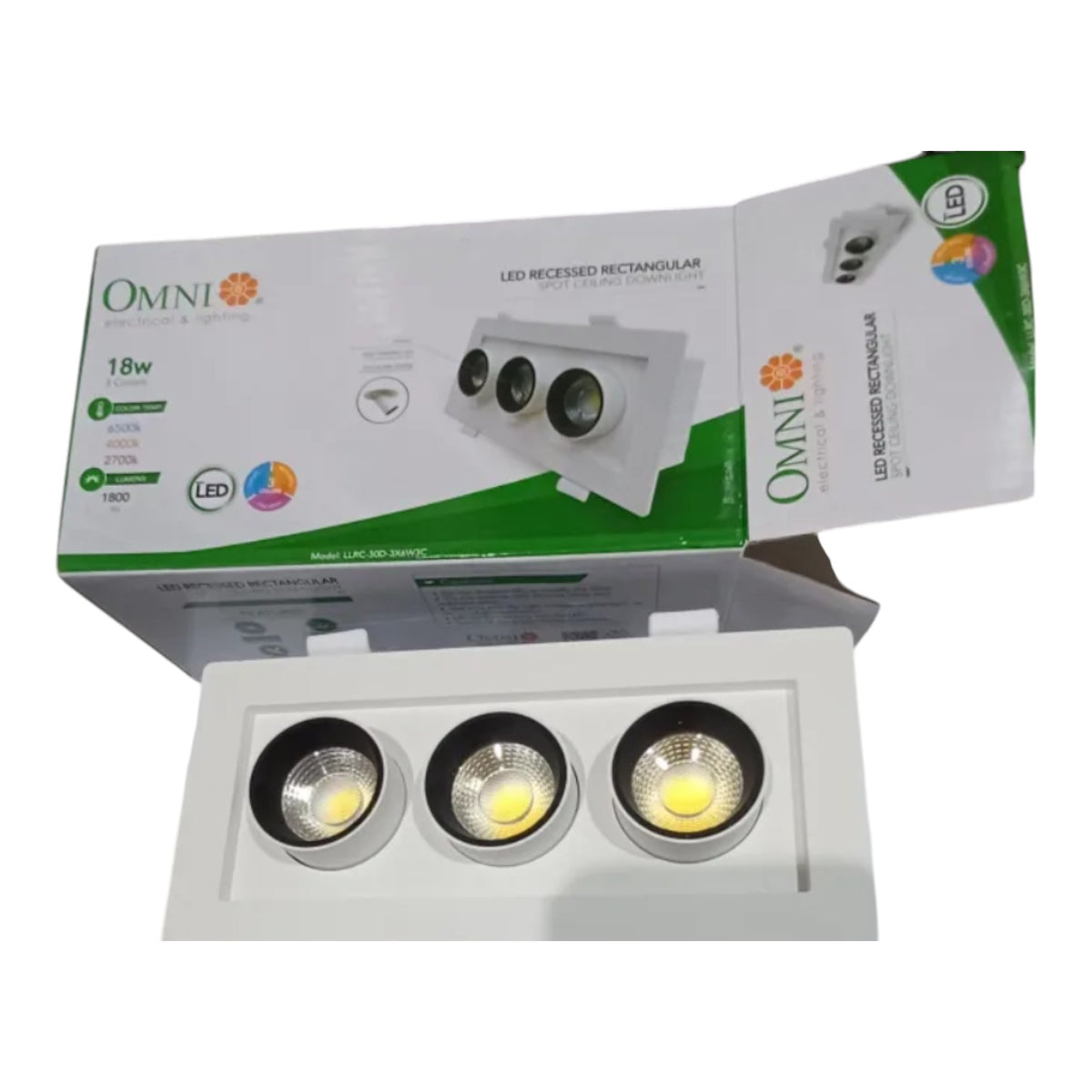 A 3-light recessed LED track spotlight shown with its retail packaging box. The white rectangular spotlight has three circular COB LED lenses, and the box features green and white branding for 'OMNI'.