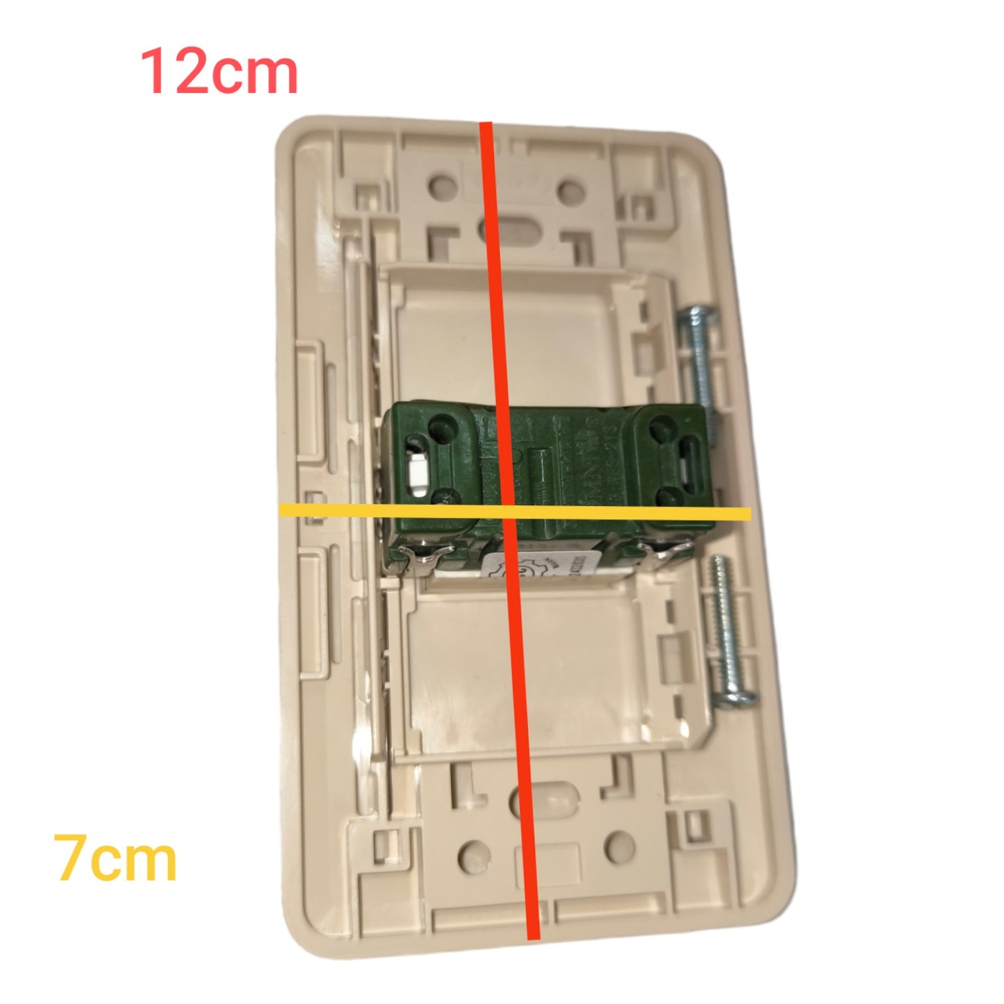 A beige plastic electrical switch plate backplate with a green mounting bracket and screws, overlaid with red and yellow dimension lines and text indicating 12cm and 7cm measurements.