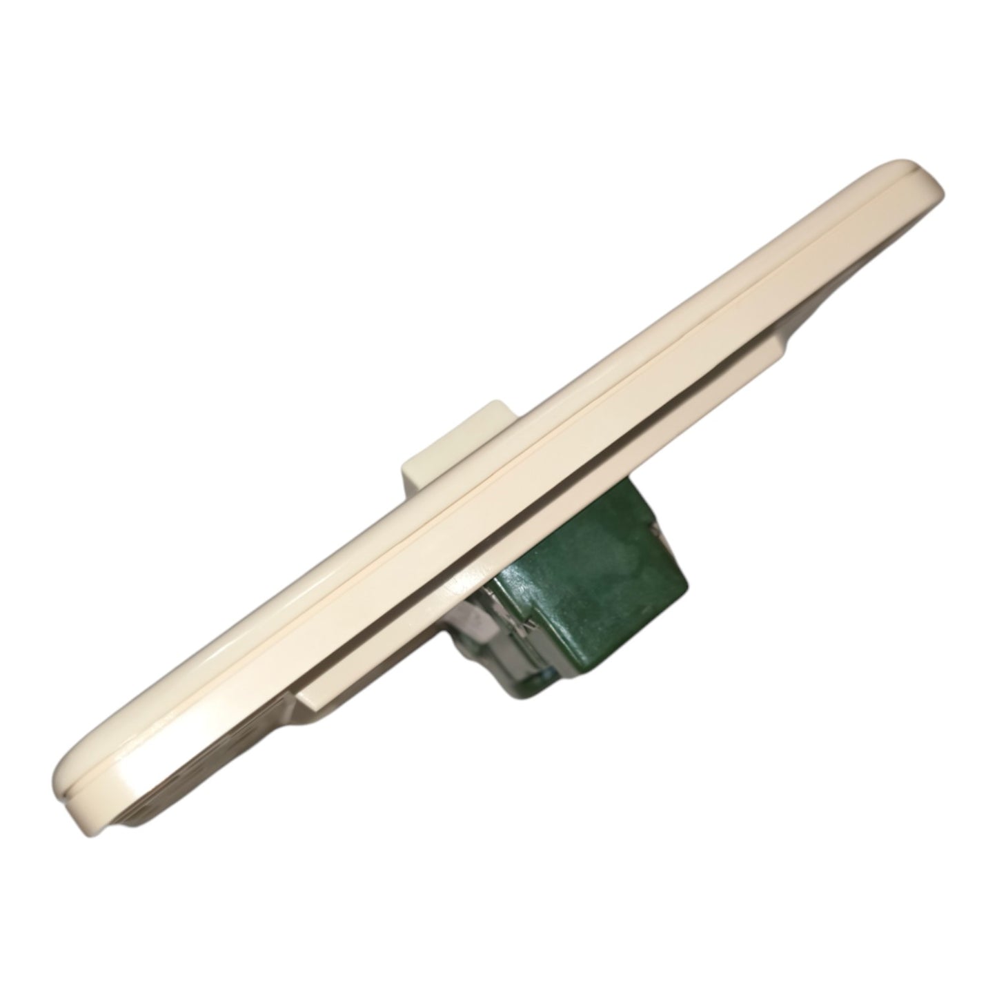 A cream-colored plastic trim piece or bracket with a green mounting base, shown on a plain white background.