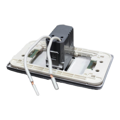 A close-up of a light switch module showing the internal components, including a black central motor or sensor unit, a beige plastic base, and two white wires with bare copper ends, isolated on a white background.