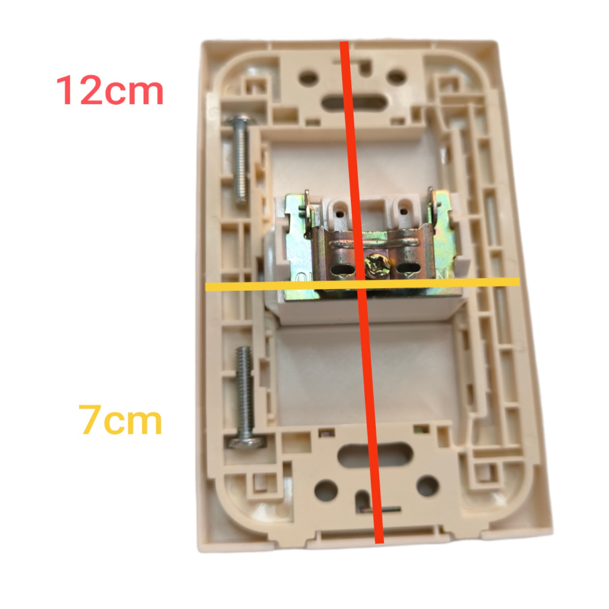 A beige plastic electrical switch socket backplate shown on a white background with red and yellow measurement lines and text indicating dimensions 12cm and 7cm.