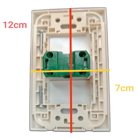 A top-down view of a beige plastic light switch backplate with a green terminal block in the center, overlaid with red and yellow measurement lines and text indicating 12cm and 7cm dimensions.
