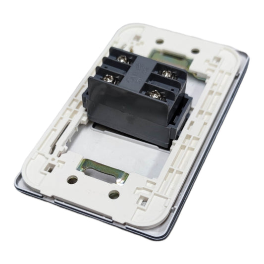 A close-up of a white electrical wall switch backplate with a black terminal block connector, isolated on a white background.