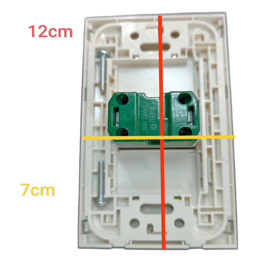 A white plastic electrical switch plate with a green terminal block connector in the center, overlaid with red and yellow measurement lines and text indicating 12cm height and 7cm width.