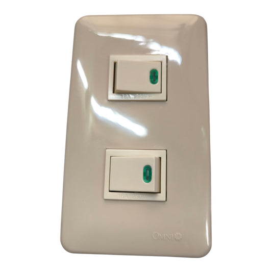 A double light switch wall plate in a glossy cream finish, featuring two individual rocker switches with green accents, on a plain white background.