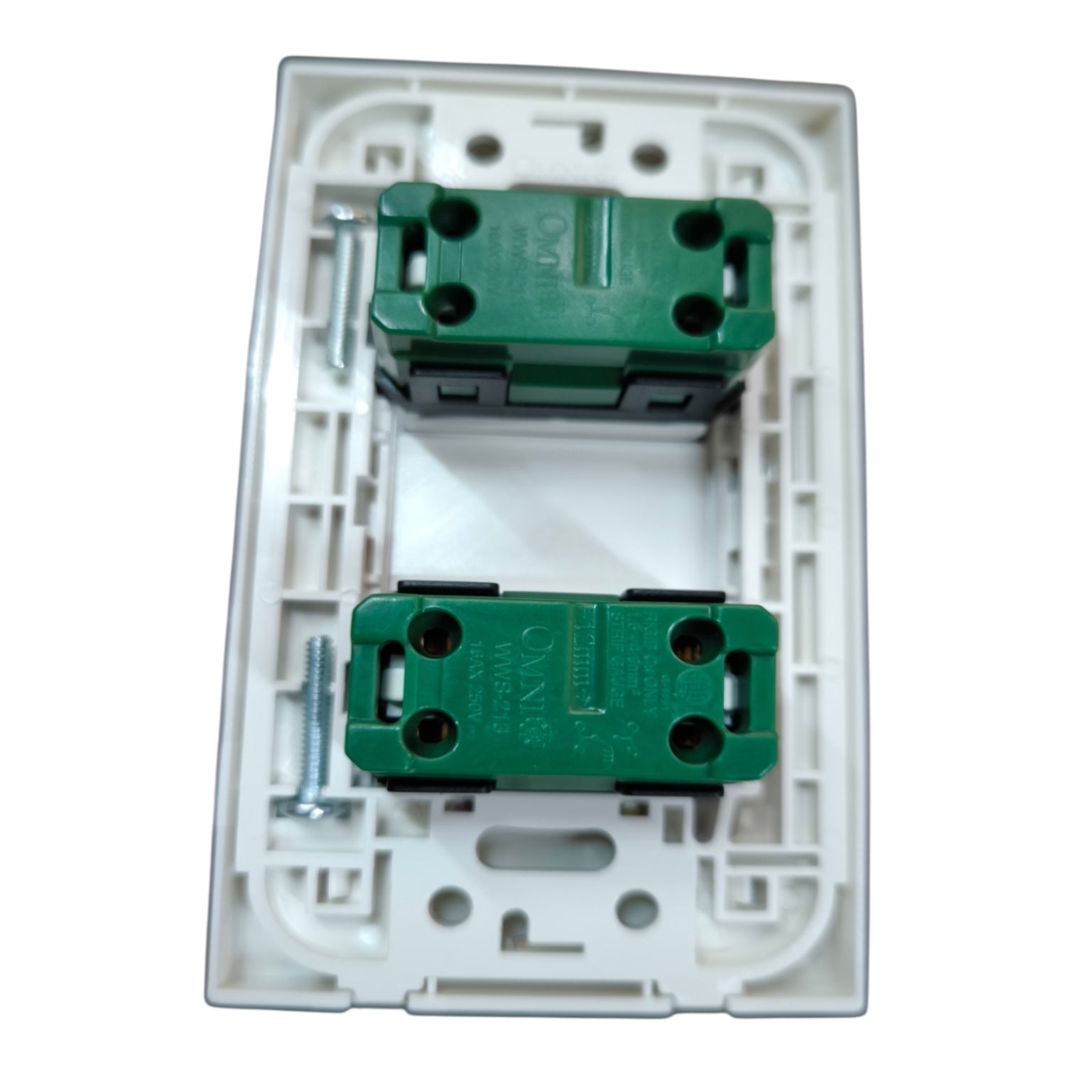 A white plastic double switch socket backplate containing two green screw terminal blocks with mounting screws, shown on a plain white background.